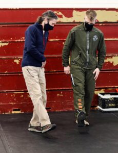 Josh Lundgaard, an athletic trainer certified with STC, Support Battalion, teaches a Marine proper form for his recovery exercise. (U.S. Marine Corps photo by Lance Cpl. Samuel C. Fletcher)